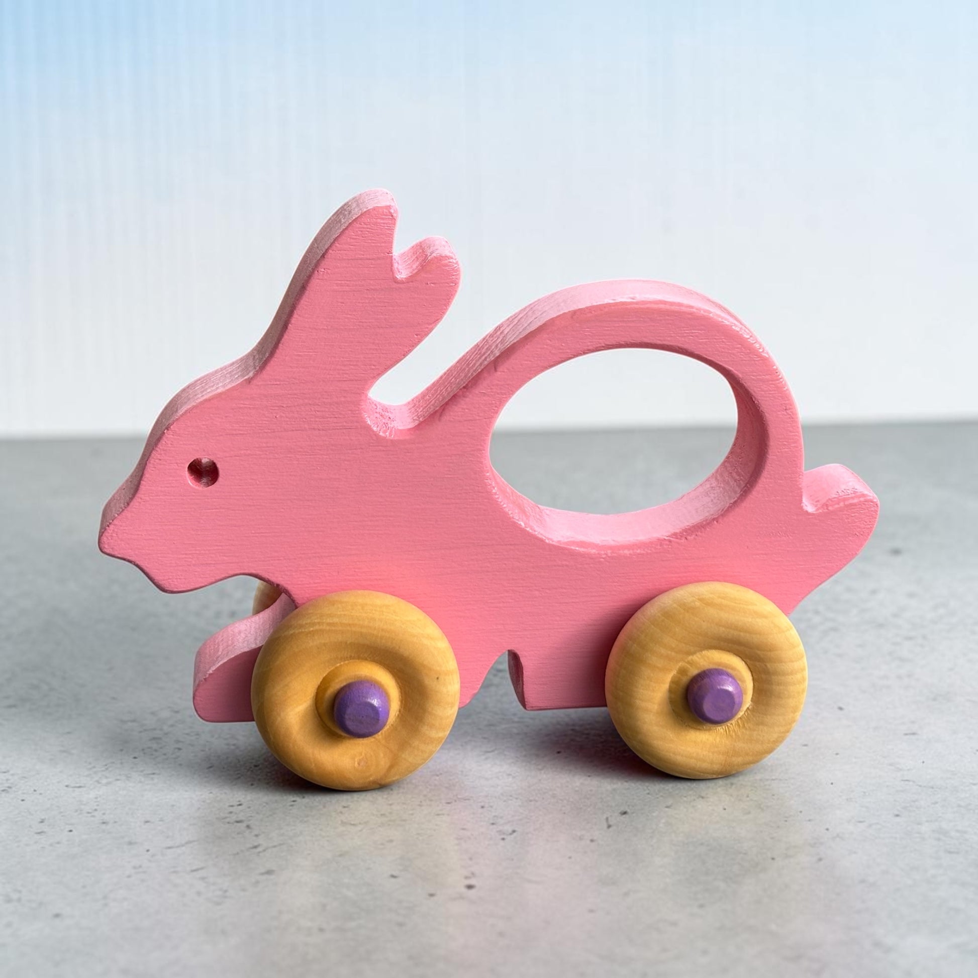Wooden Bunny Push Toy Toddler Walking Aid Natural Pine Wood Construction Non Toxic Pink Paint Finish Purple Wheel Centers Safe Baby Toy First Steps Support Motor Skill Development Balance Building Exercise Perfect Birthday Gift Handcrafted